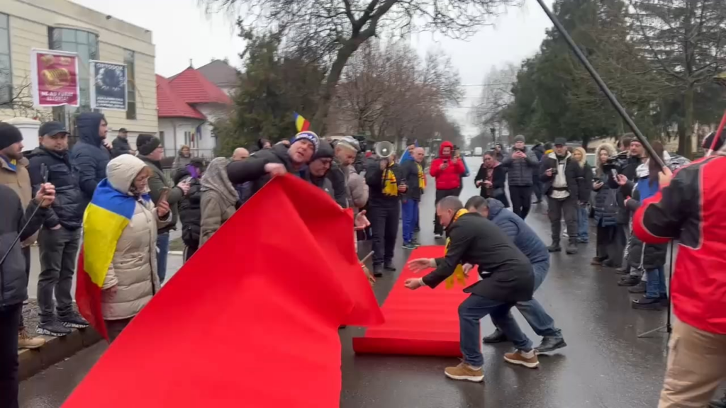 Georgescu's supporters spread the red carpet in front of the Buftea Police headquarters. I think Simion is crying now