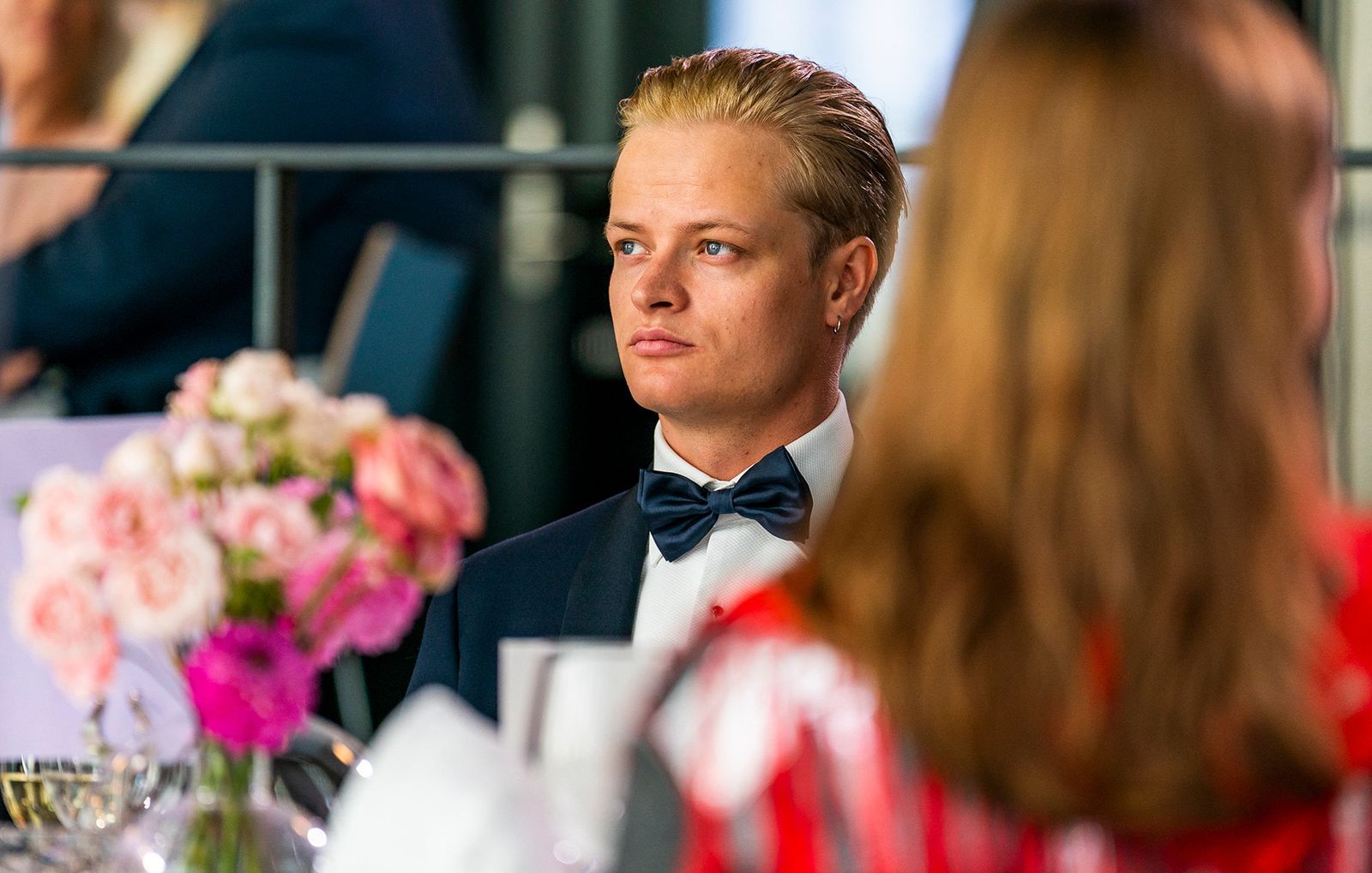 Image may contain Accessories Formal Wear Tie Blonde Hair Person Clothing Suit Adult Head Face and Photography
