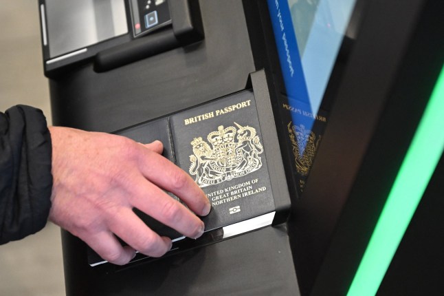 A person as their passport scanned whilst using an Automated European Union Entry/Exit System (EES) kiosk during a press preview on the rollout of the EU's new Entry-Exit System (EES) at Eurotunnel, south east England on September 23, 2025. The European Union's new border-check system for non-EU nationals, the so-called Entry/Exit System (EES), which will do away with passport stamps, is set to finally launch October 12. (Photo by Justin TALLIS / AFP) (Photo by JUSTIN TALLIS/AFP via Getty Images)
