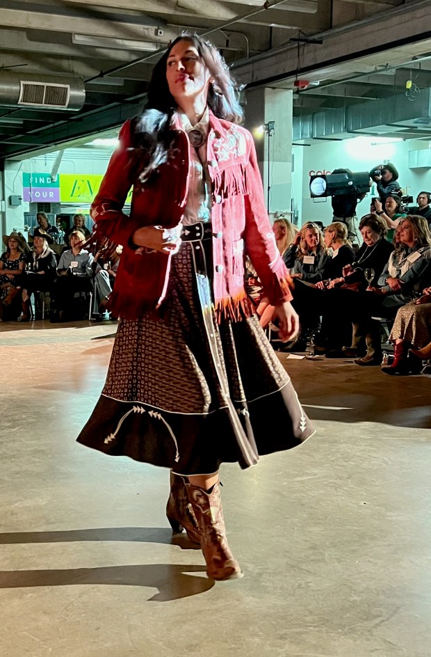The suede jacket with fringe, full skirt and boots are part of Double D Ranchwear's signature look. (Suzanne S. Brown, Special to The Denver Post)