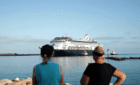 Two passengers in Geraldton looking at a cruise ship.