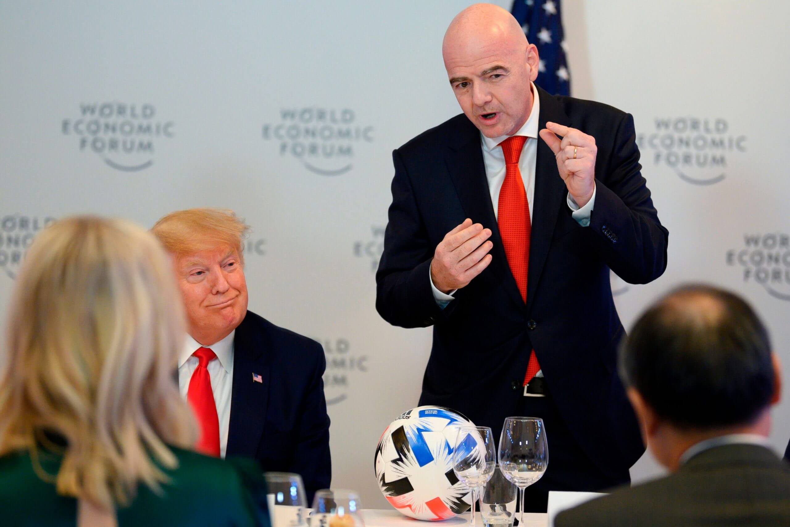 Gianni Infantino stands up to talk at a conference