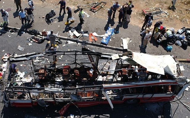 Police and paramedics inspect the scene after a suicide bomber blew himself up on a rush-hour bus near the Jerusalem neighborhood of Gilo during the Second Intifada, on June 18, 2002 (photo credit: Flash90)