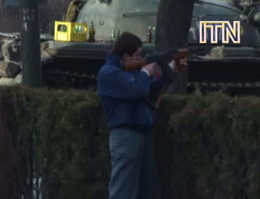 Romanian revolutionary engages Ceausescu loyalists in Bucharest, 12/23/1989