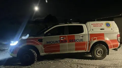 Mourne Mountain Rescue Team A Mourne Mountain Rescue Team 4X4, it is white and orange