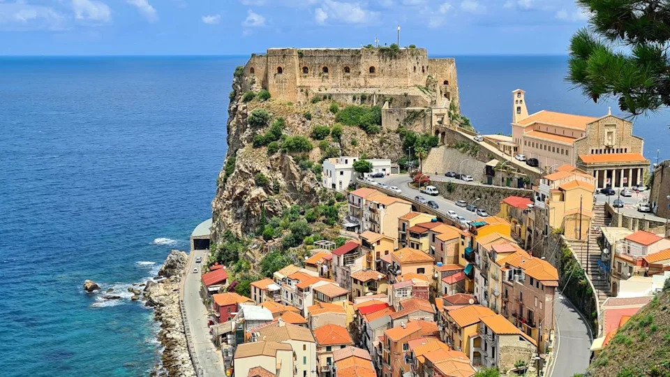 Scilla, Calabria, Italy - July 05 2023: The majestic fortress "Castello Ruffo di Scilla", which rises on a rocky cliff above the Tyrrhenian Sea.Scilla, Calabria, Italy - July 05 2023: The majestic fortress "Castello Ruffo di Scilla", which rises on a rocky cliff above the Tyrrhenian Sea.