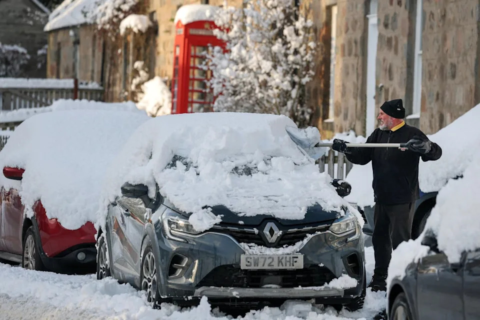 A man shovels snow as an 'amber' snow warning was issued on January 02, 2026 in Kincardine O'Neil, Scotland (Photo by Jeff J Mitchell/Getty Images) (Getty)