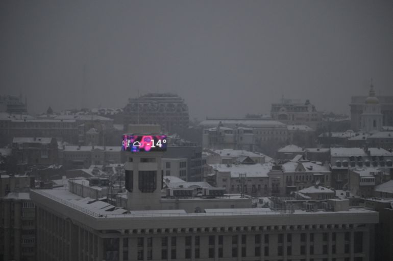 TOPSHOT - This photograph shows a big screen on a building displaying a temperature of -14 degrees Celsius in Kyiv on January 14, 2026, amid the Russian invasion of Ukraine.
