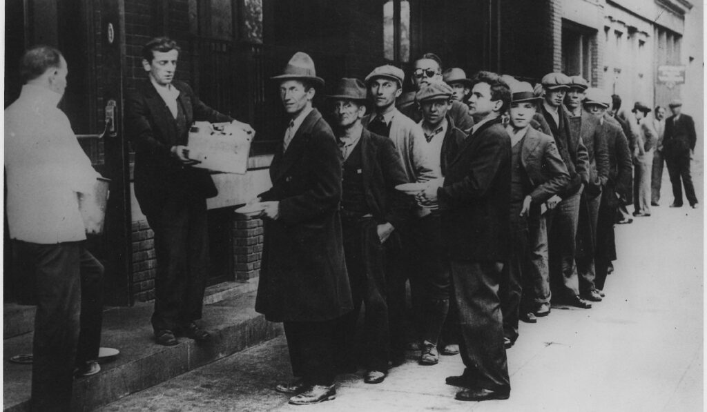 Depression: Breadlines:long line of people waiting to be fed: New York City: in the absence of substantial government relief programs during 1932, free food was distributed with private funds in some urban centers to large numbers of the unemployed