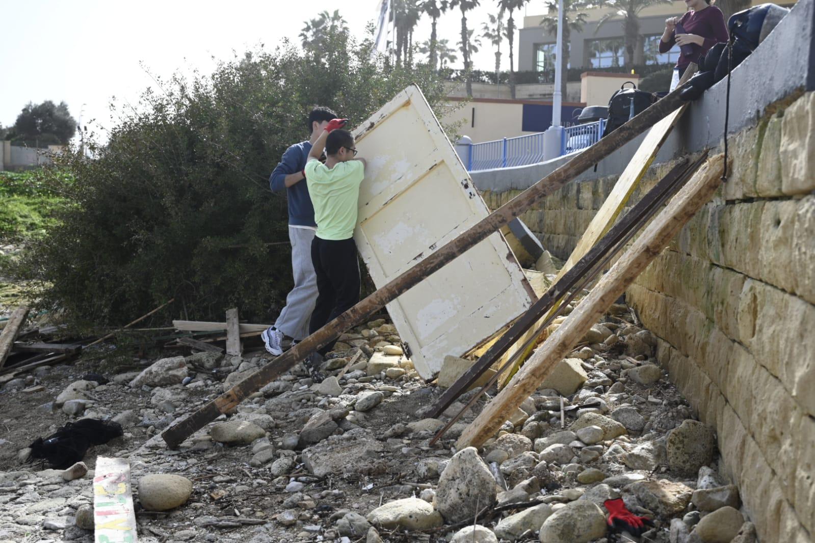 Volunteers in Dragonara cleaning debris after the storm Photo: Matthew Mirabelli