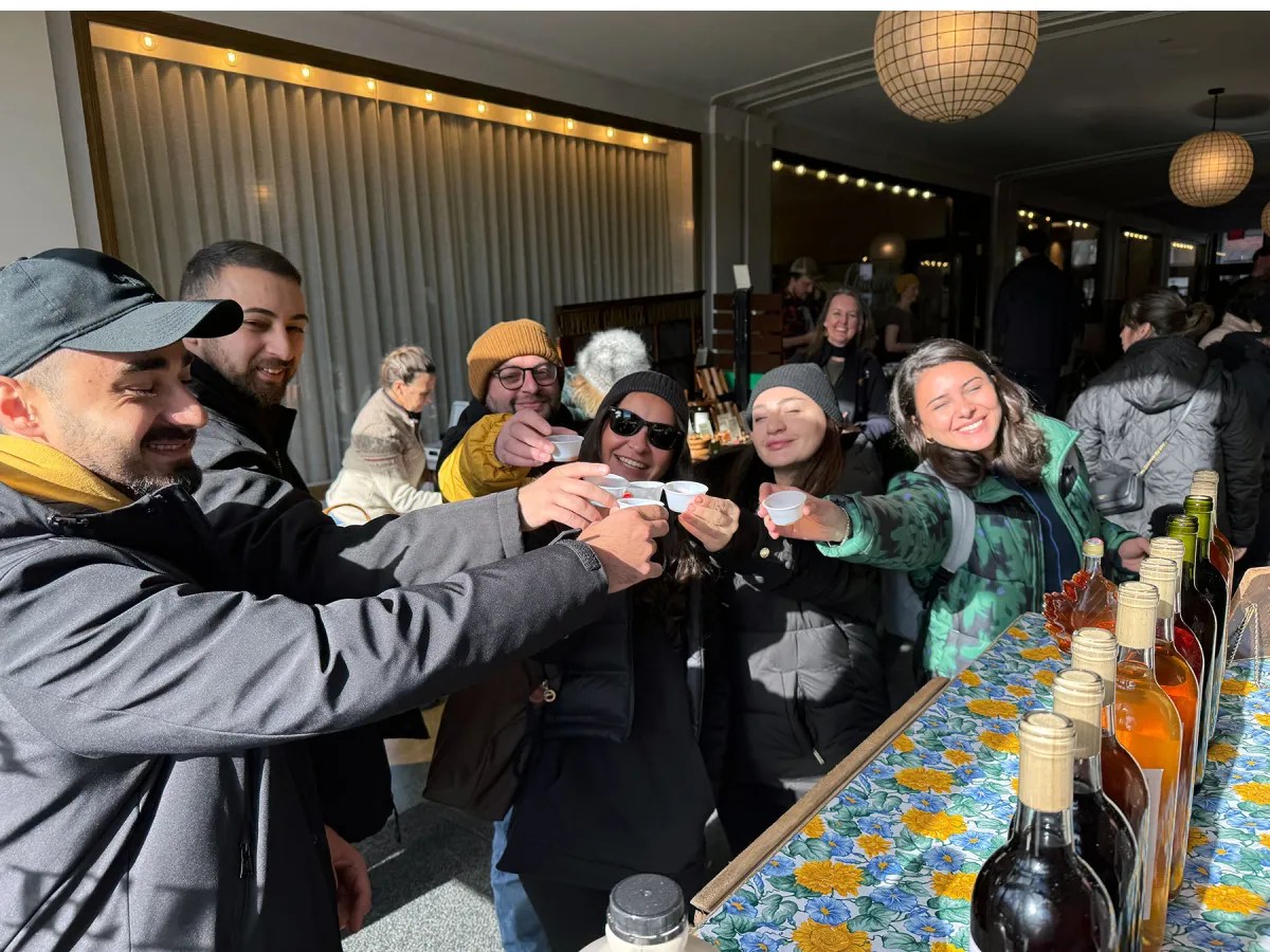 Members of the Georgian Farmers’ Association sample maple syrup for the first time at the Saranac Lake Farmers Market at Hotel Saranac. From left to right: Simon Tsikarishvili, Giorgi Khuroshvili, Koba Zhorzhikashvili, Mariam Mebaduri, Tamta Mamulaidze, Dali Barjadze.