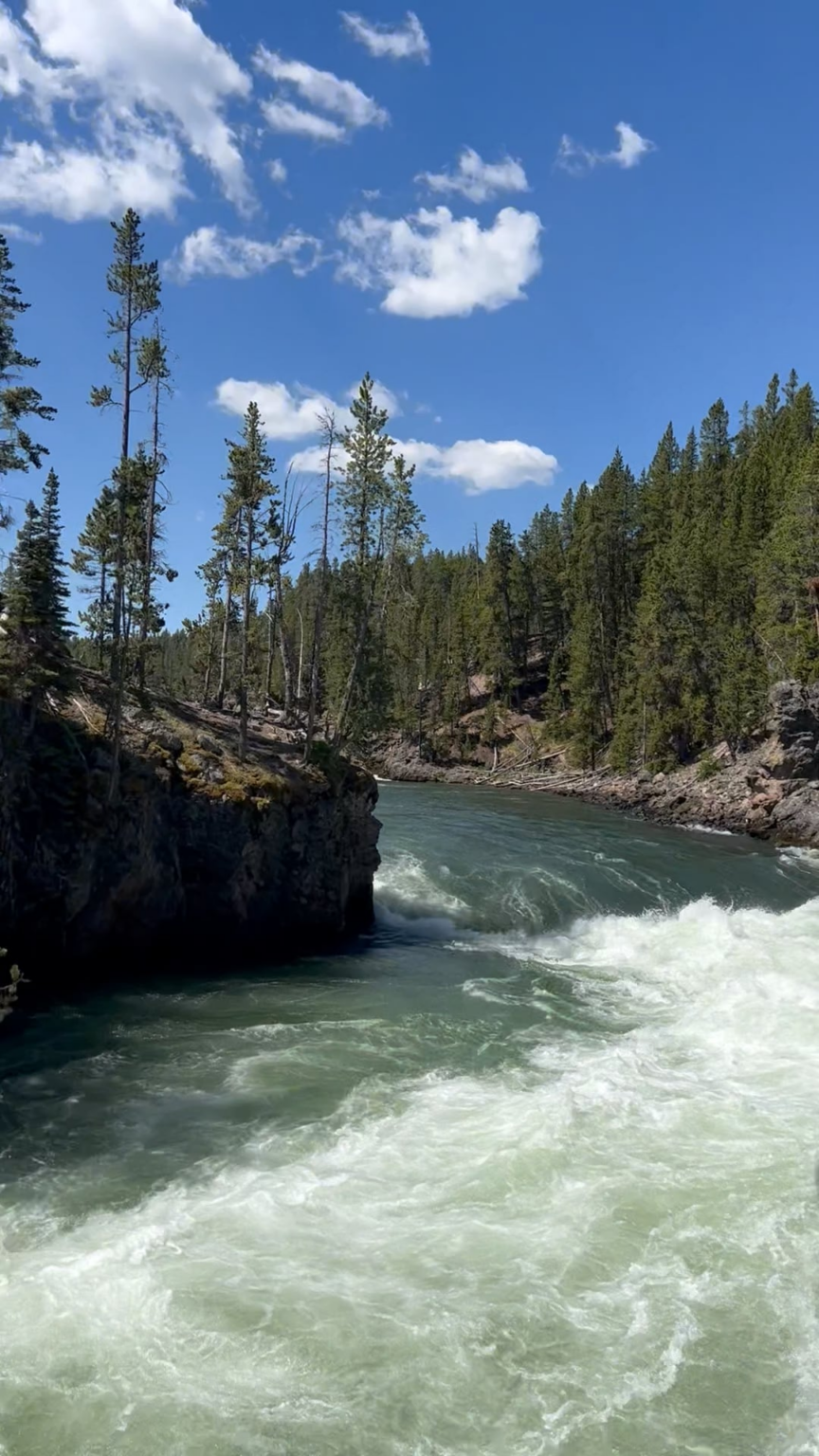 Standing over the edge of the 109-foot Upper Falls, Yellowstone