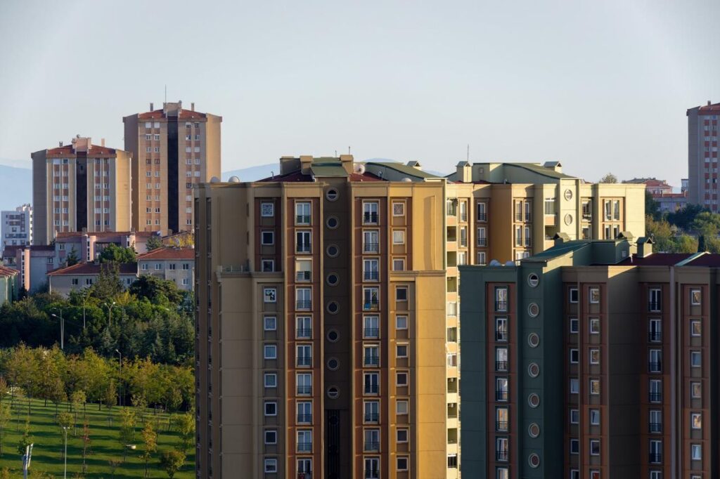A cluster of high-rise residential buildings stands in a row, reflecting modern urban development in Istanbul, Türkiye. (Adobe Stock Photo)