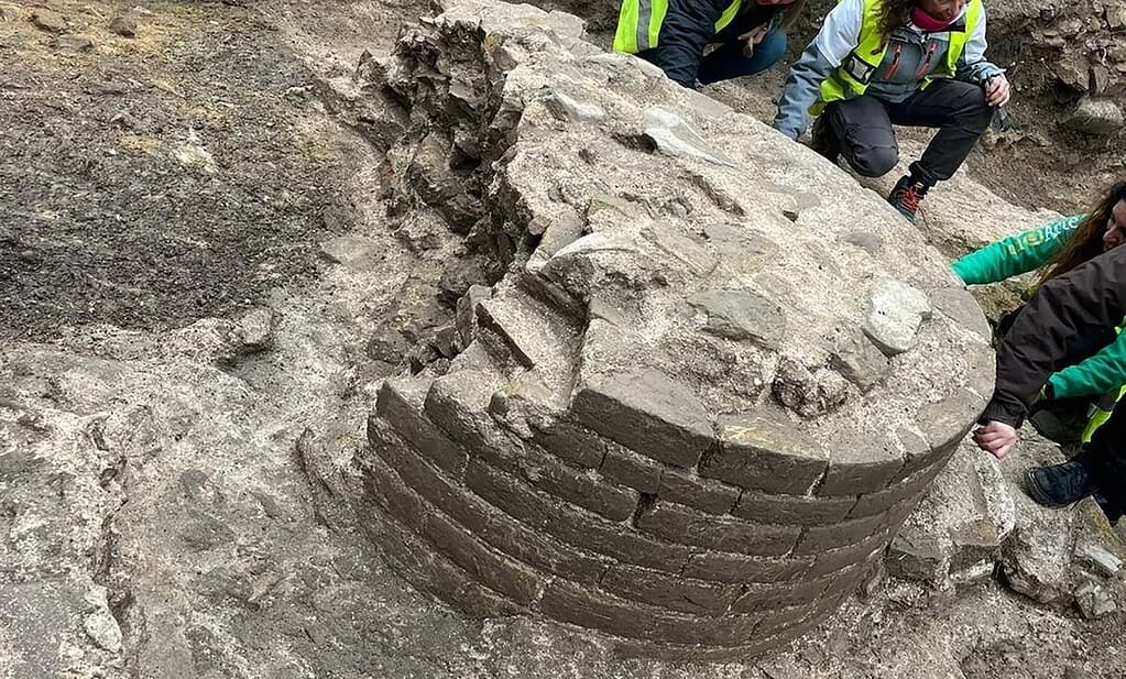 Portion of stone column at Fano archaeological site being excavated by archaeologists