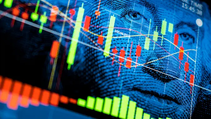 Stock market chart displayed over a blue image of George Washington from the $1 bill, connecting investing and U.S. money.