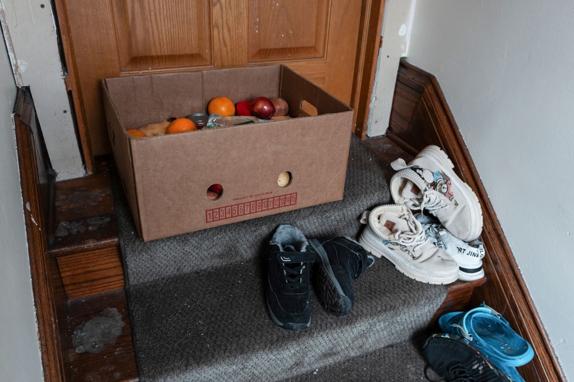 Food is left at an apartment door by Sergio Amezcua, a pastor at Dios Habla Hoy, on January 16.  Minneapolis residents have joined a church-run effort to deliver donated groceries to immigrant families who fear leaving their homes.
