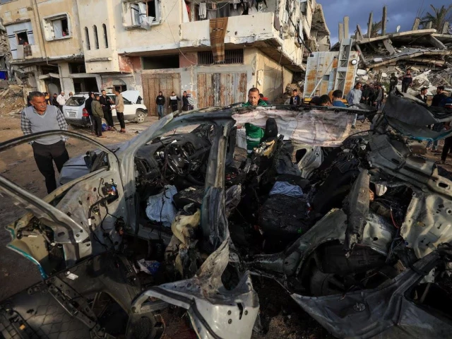 palestinians inspect the site of an israeli strike on a car in gaza city december 13 2025 photo reuters