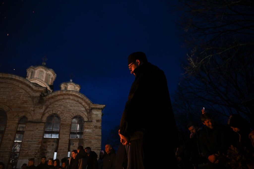 Kosovo Serbs gather around a bonfire during the ceremonial burning of dried oak branches, symbolizing the Yule log, on the eve of the Orthodox Christmas, at the monastery in Gracanica on January 6, 2026. (AFP Photo)