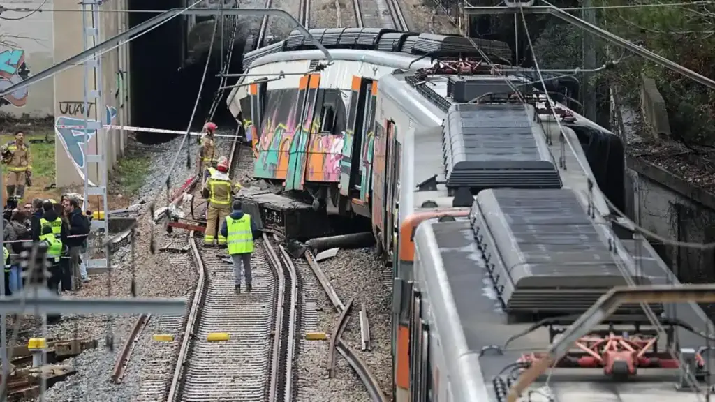 A trainee driver was killed when a wall crashed on to his cab in Catalonia in heavy rain