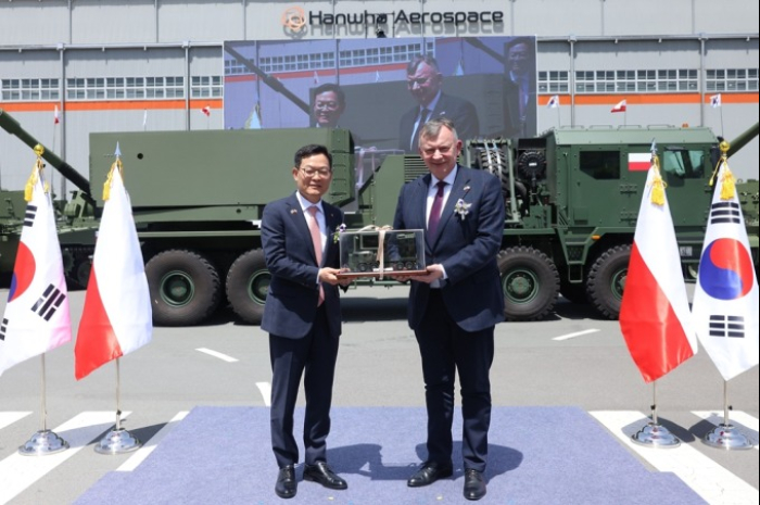 Hanwha Aerospace CEO Son Jae-il (left) and Artur Kuptel, head of the Polish State Armament Agency, sign a />.6 billion Chunmoo rocket launcher deal on April 25, 2024