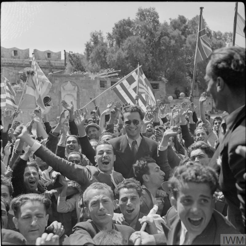 Rhodes 18 May 1945: Citizens with British, American and Greek flags celebrate the liberation of the island