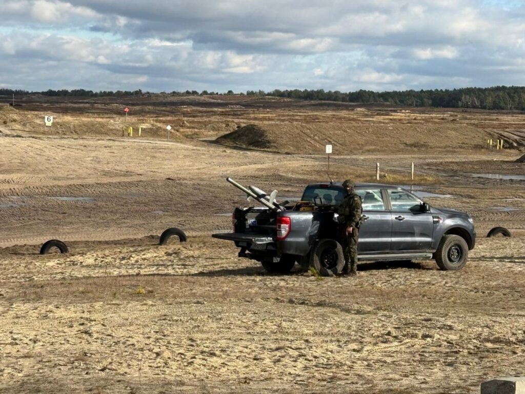 Romania to Deploy Low-Cost Counter-Drone System Proven in Ukraine The Merops counter-drone system placed on a black truck bed with a soldier operating it.