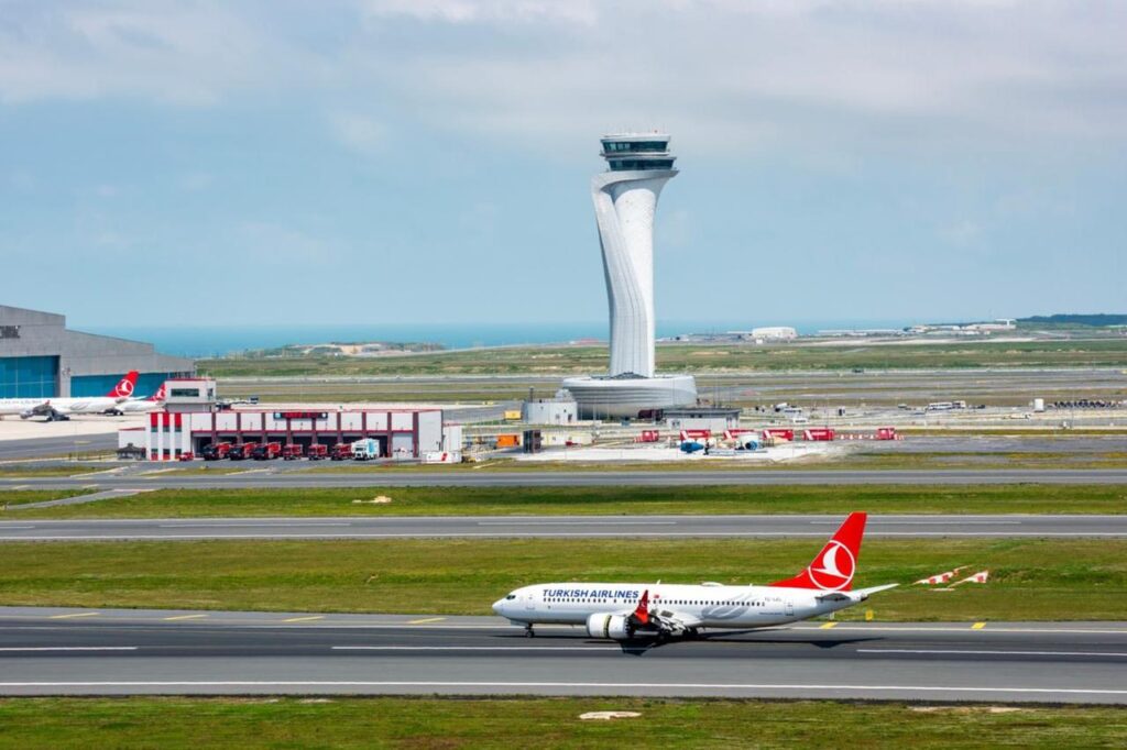 Turkish Airlines airplane with Air Traffic Control Tower of Istanbul Airport in Istanbul, Türkiye on June 3, 2023. (Adobe Stock Photo)