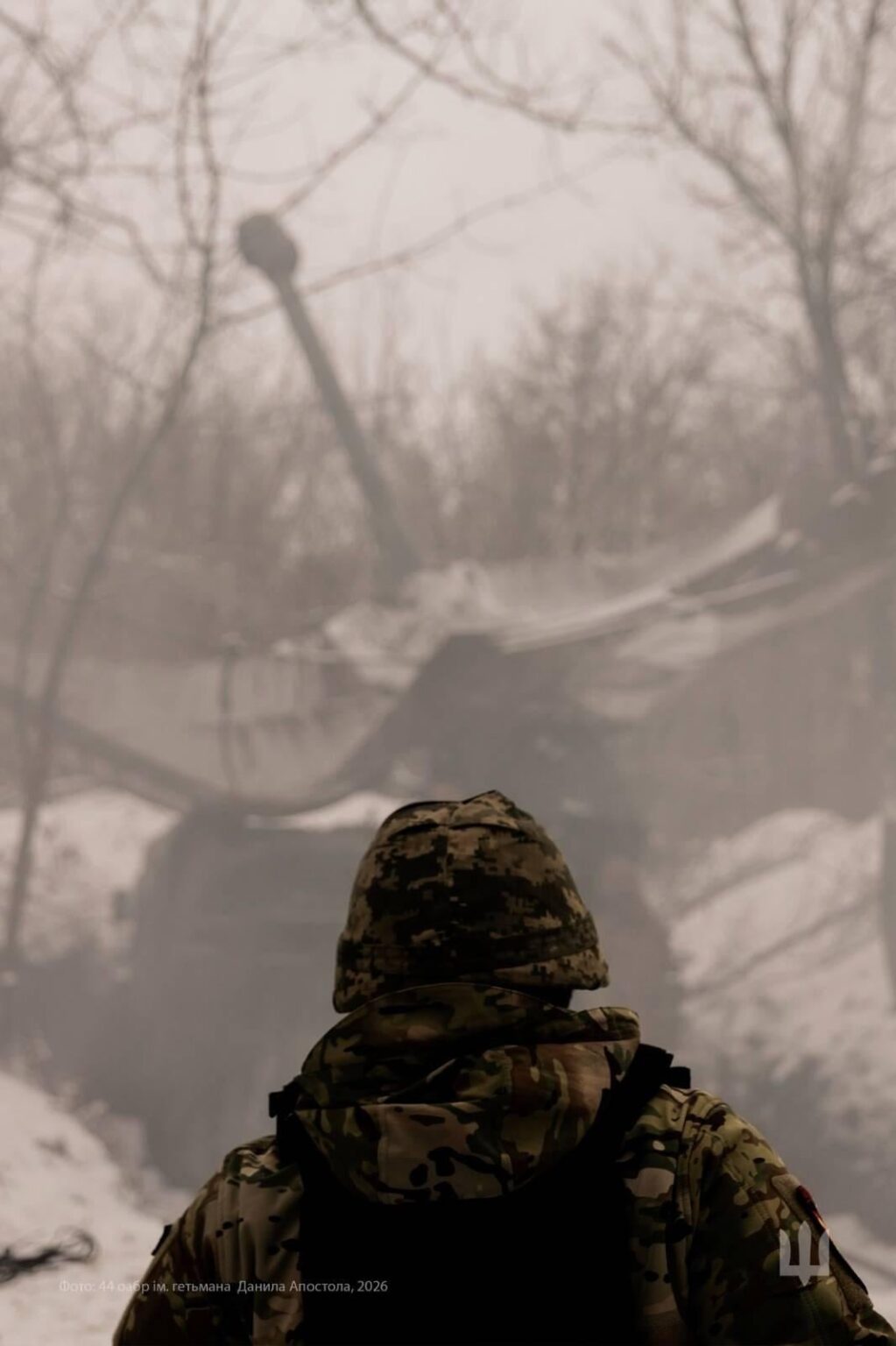 Ukrainian soldier looks toward the position of a self-propelled howitzer (SPH, from the 44th Separate Artillery Brigade named after Hetman Danylo Apostol - of the Ukrainian Army.