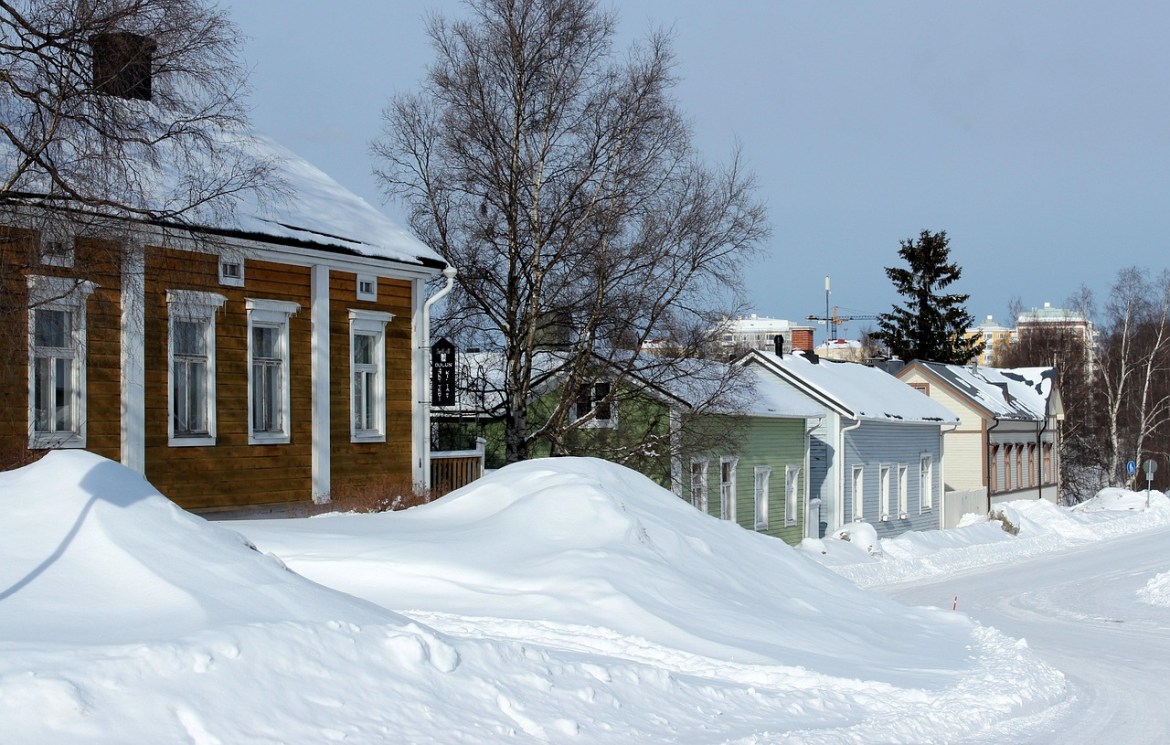 Snow-covered wooden houses in Oulu, Finland, a less-visited destination gaining attention in travel trends 2026.