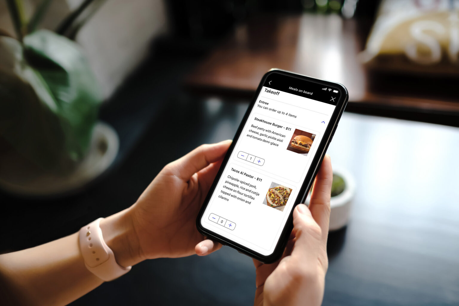A united airlines passenger preordering a meal prior to their flightvia the United App