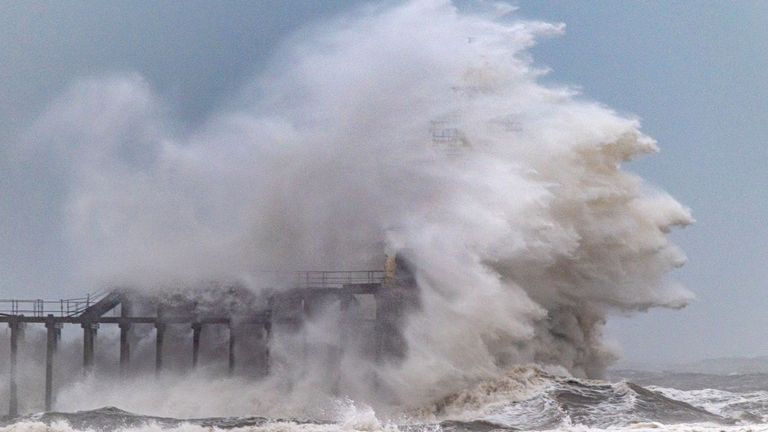 Waves crash over Blyth Pier lighthouse in Northumberland.
Pic: Cover Images/AP 