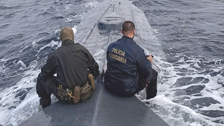 Portuguese authorities drug officers sits atop to sub - which they say sailed across the Atlantic.
Pic: Portugal's Judicial Police
