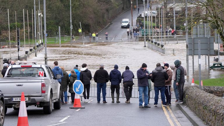 People watching the banks of the River Slaney flood in Enniscorthy, Co Wexford. Pic: PA