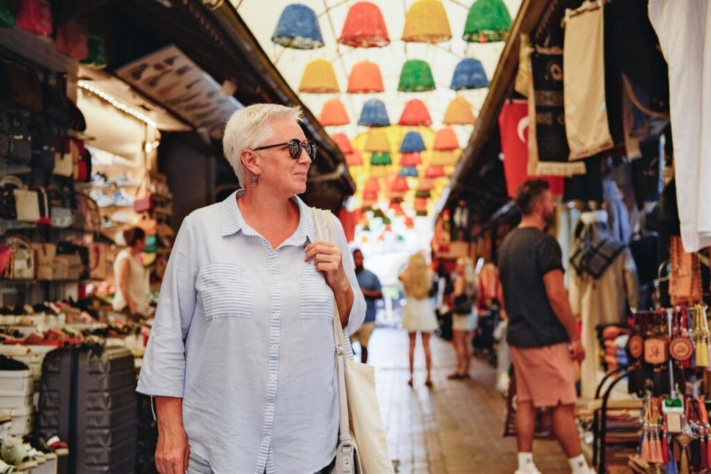 An older woman strolls through a traditional market in Türkiye. (Adobe Stock Photo)