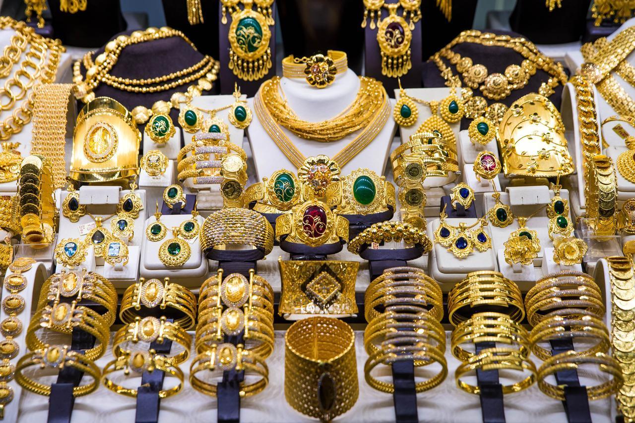 A wide selection of ornate gold jewelry displayed for sale in a shop at Grand Bazaar in Istanbul, Türkiye. (Adobe Stock Photo)