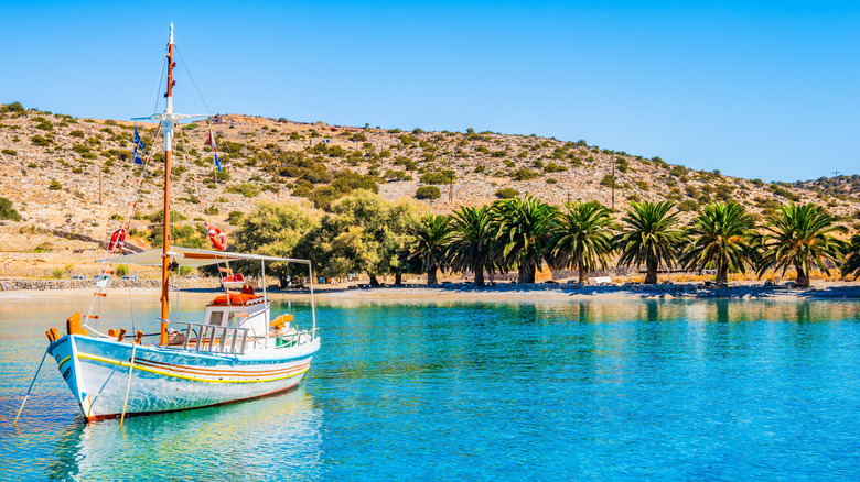 Fishing boat in crystal clear waters in Naxos, Greece
