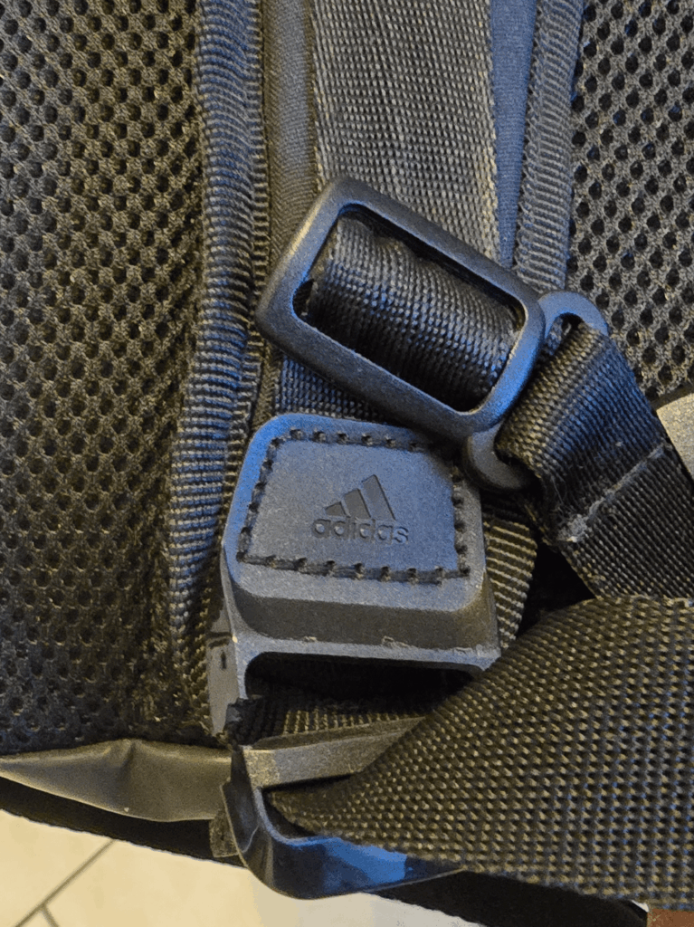 Where can I find a replacement strap clip for my Adidas backpack?