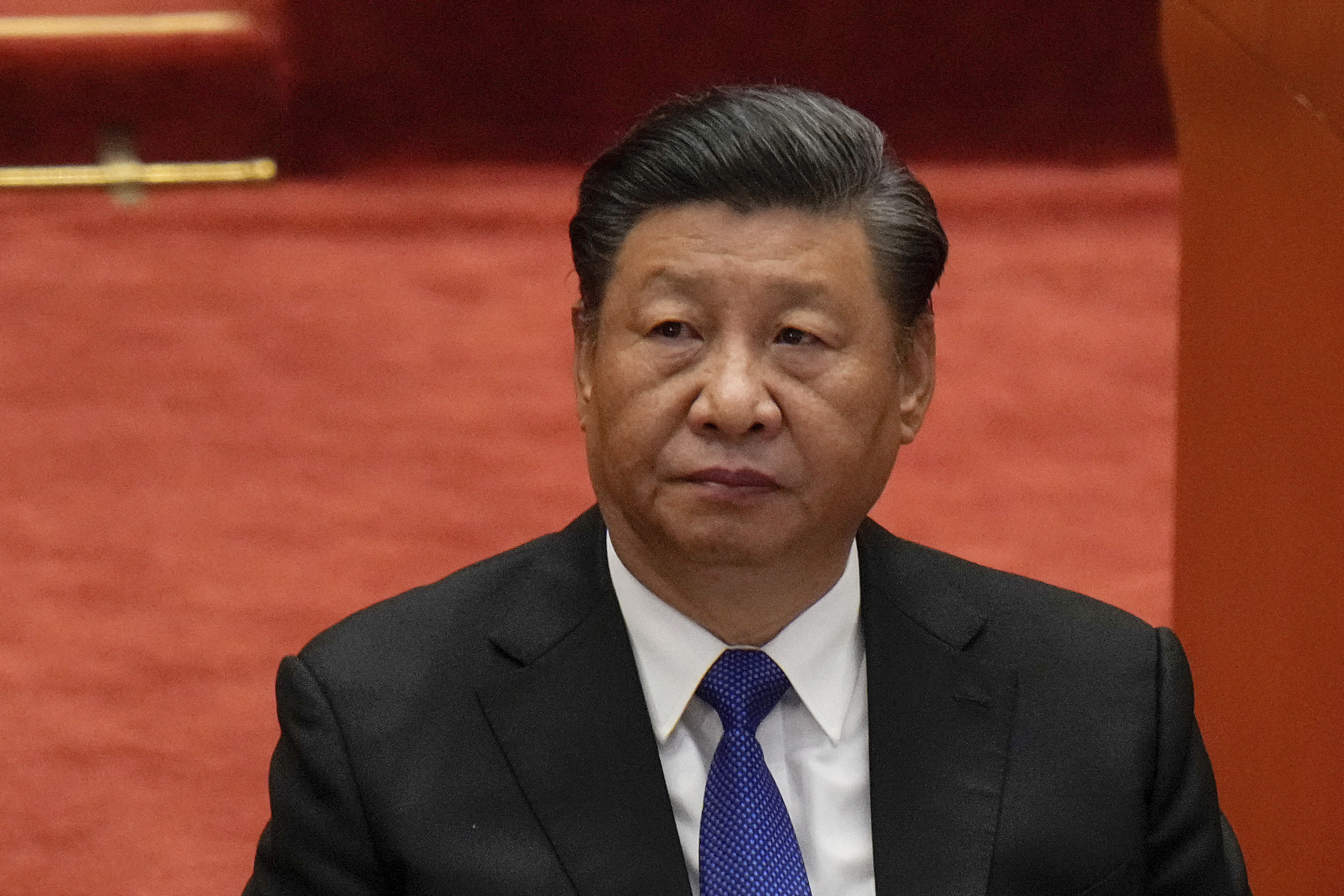 Chinese President Xi Jinping in a black suit and blue tie.