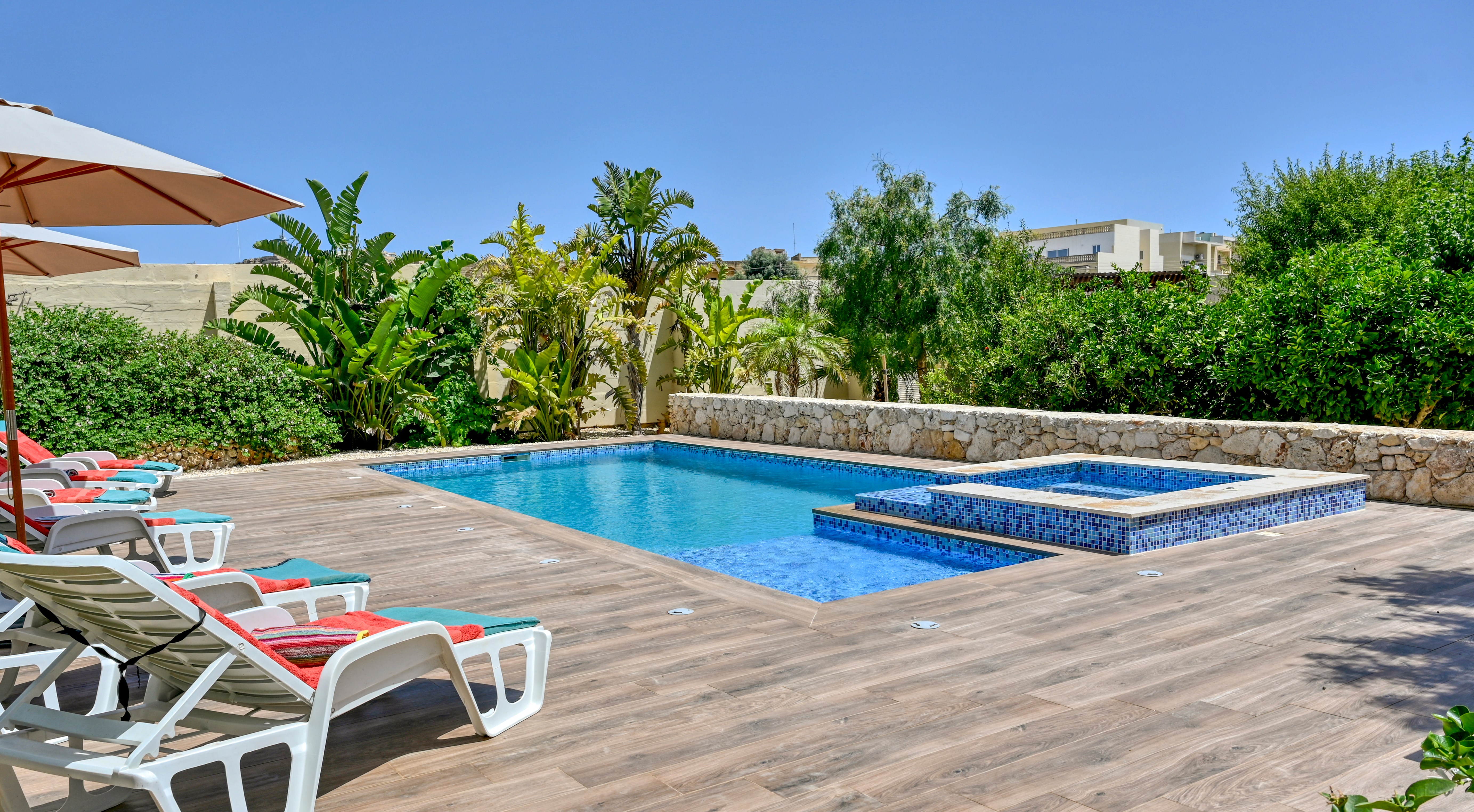 Outdoor swimming pool and hot tub at Villa Gozo Garden.