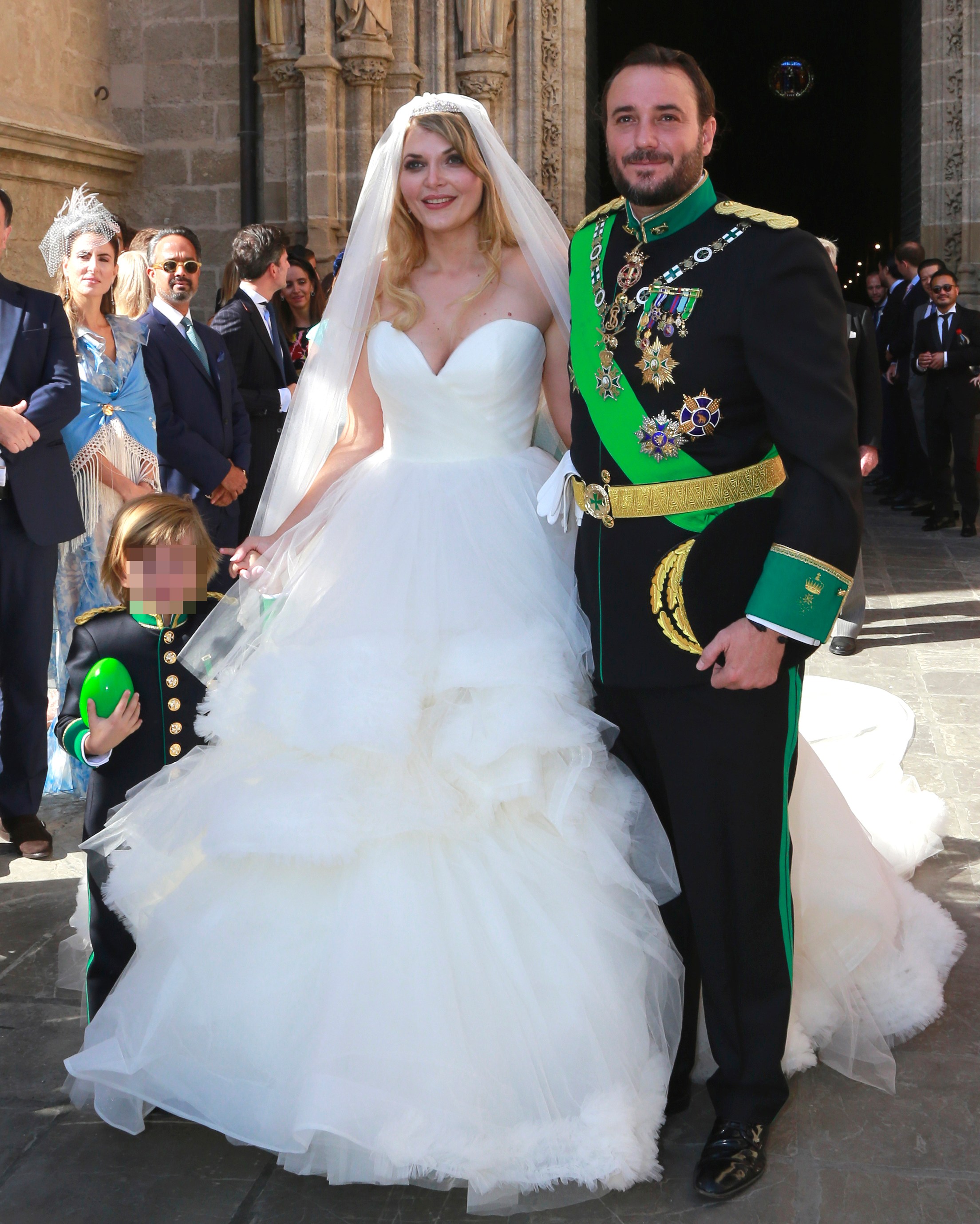 Sophie Karoly and Francisco de Borbon leave their wedding with their son.