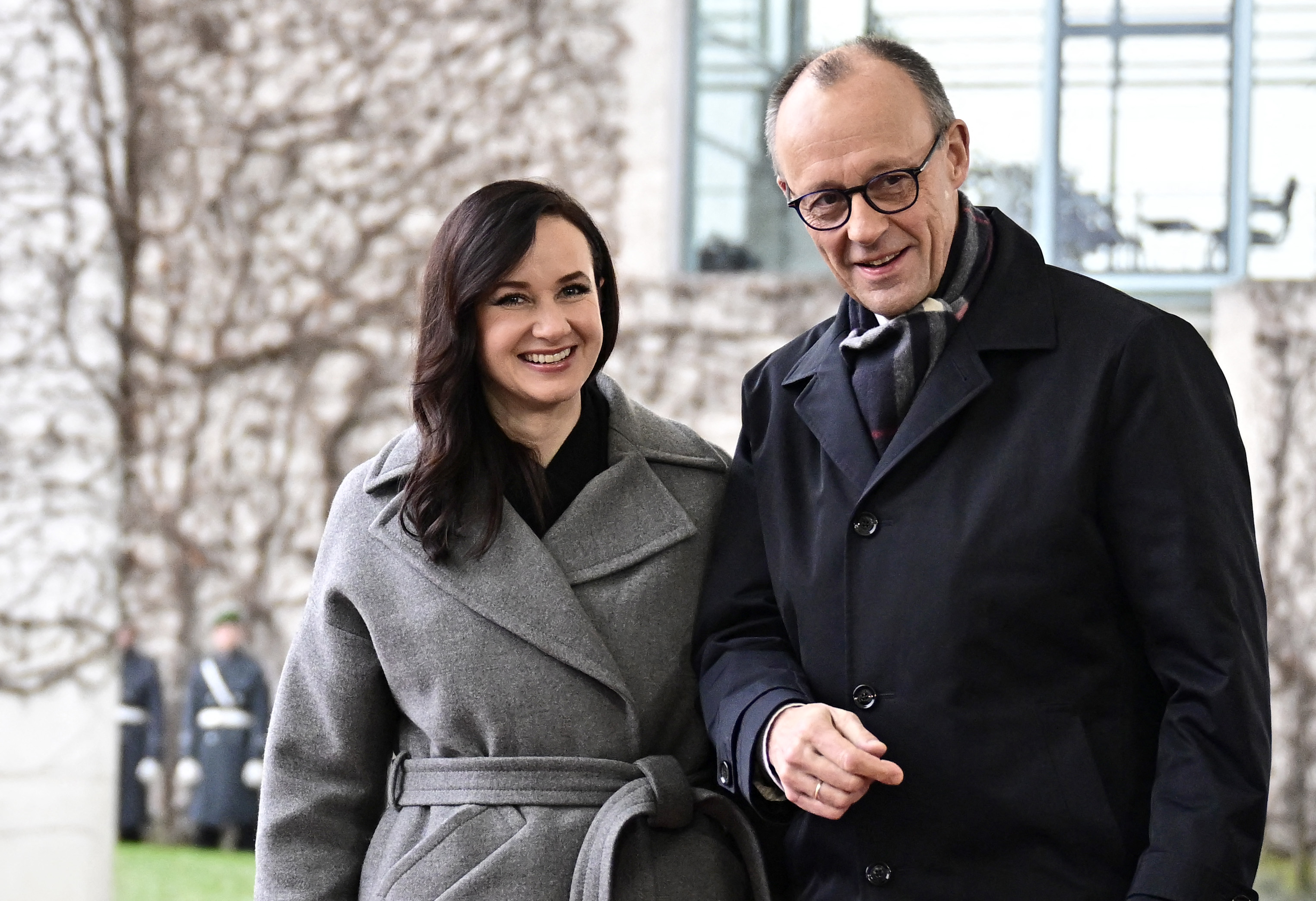 German Chancellor Friedrich Merz and Lithuania's Prime Minister Inga Ruginiene smiling.