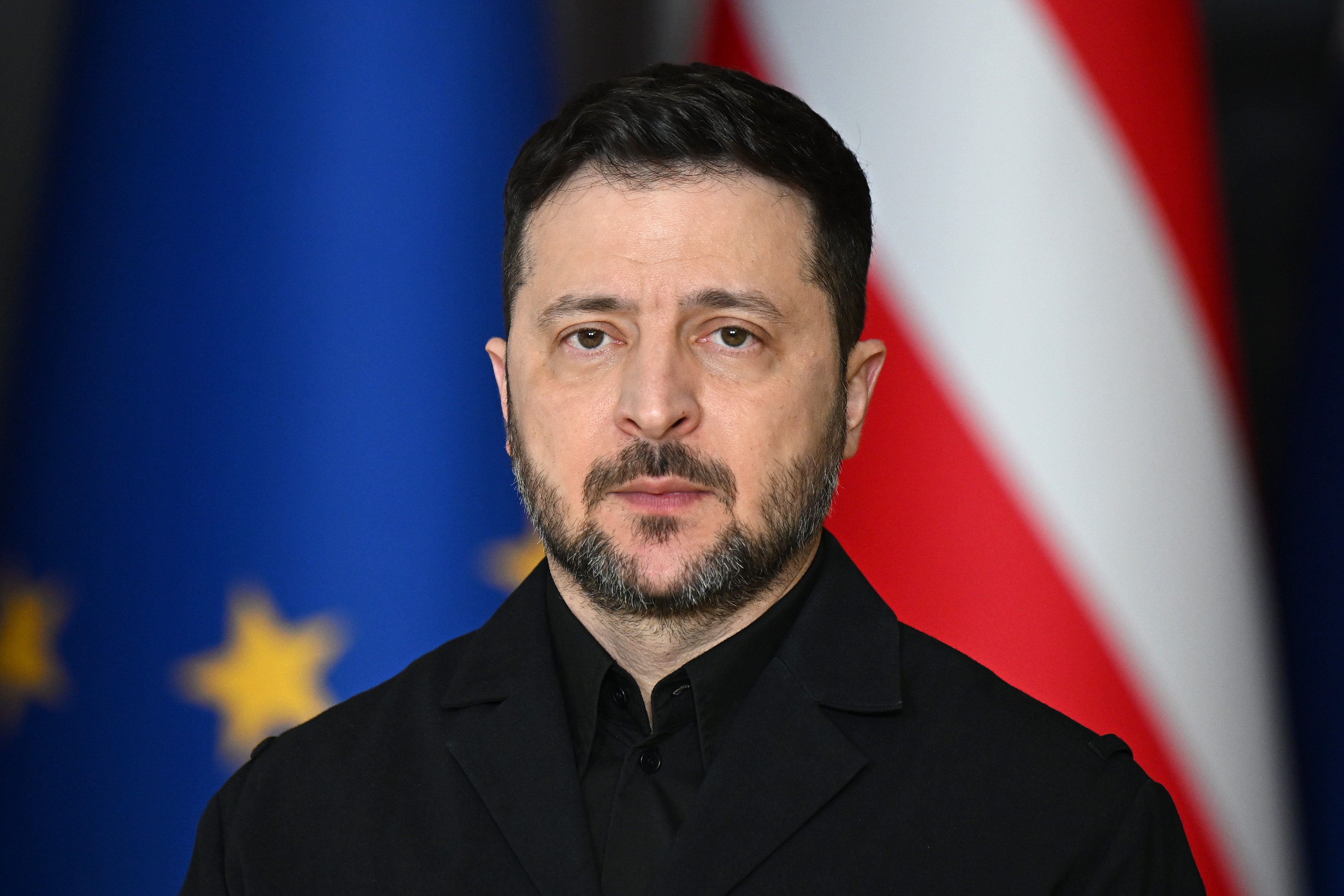 Ukrainian President Volodymyr Zelensky standing in front of flags, during the fourth anniversary of Russia's large-scale invasion of Ukraine.