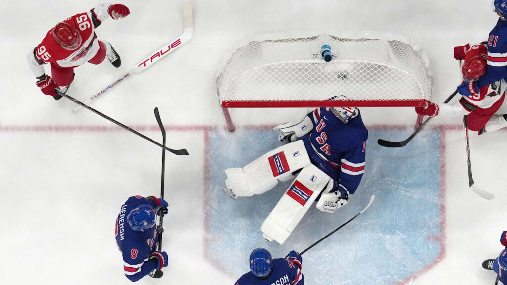 Feb 14, 2026; Milan, Italy;  Jeremy Swayman of United States saves a shot from Patrick Russell of Denmark in men's ice hockey group C play during the Milano Cortina 2026 Olympic Winter Games at Milano Santagiulia Ice Hockey Arena. Mandatory Credit: Geoff Burke-Imagn Images