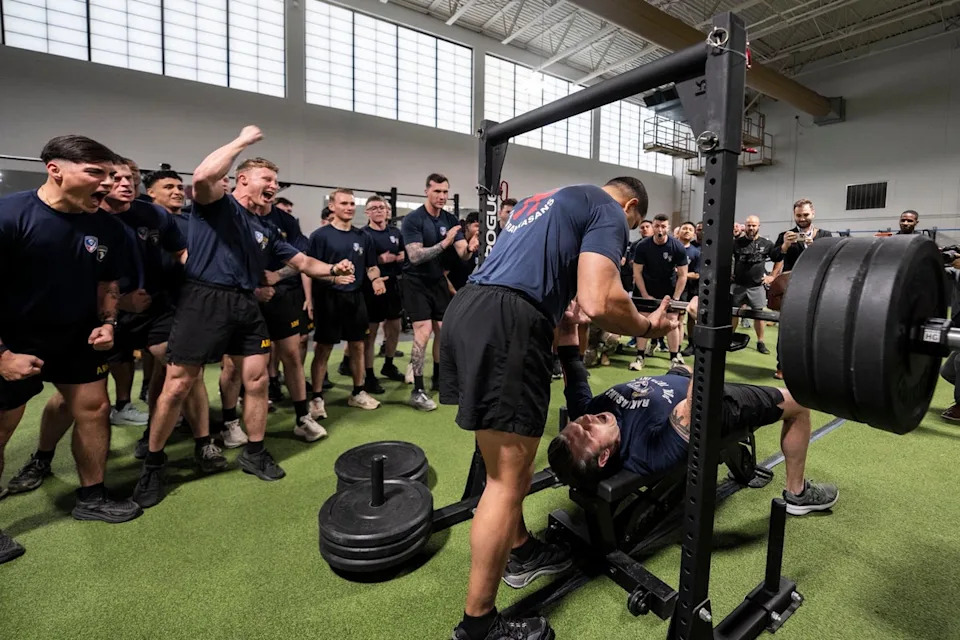 In another video shared Friday, Hegseth, a military veteran, was cheered on by troops at his former base Fort Campbell as he bench-pressed in front of them (@SecWar/X)
