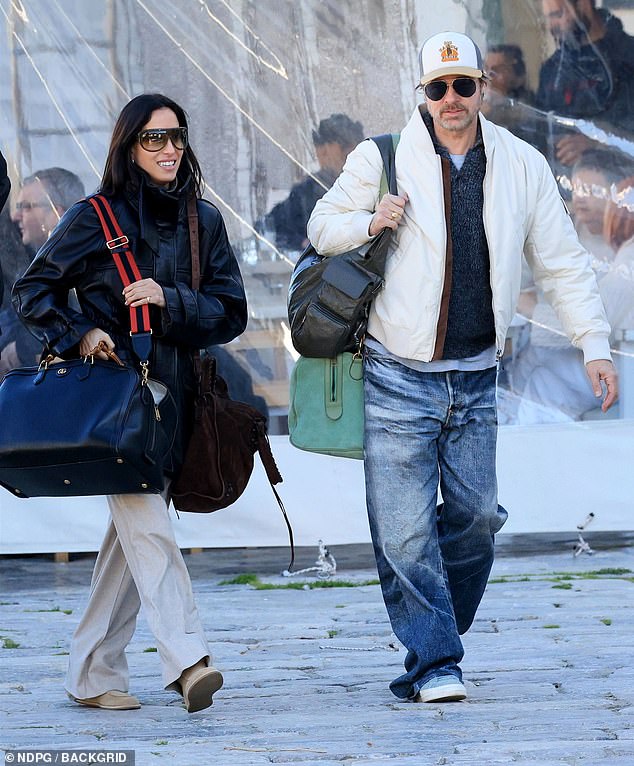 Pitt looked effortlessly cool in a white jacket, oversized denim jeans and a baseball cap