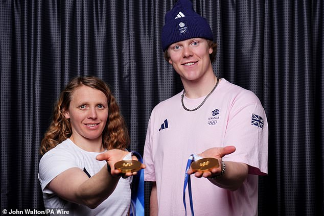 Charlotte Bankes and Huw Nightingale, who won gold in the mixed team snowboard cross event, pose with their medals