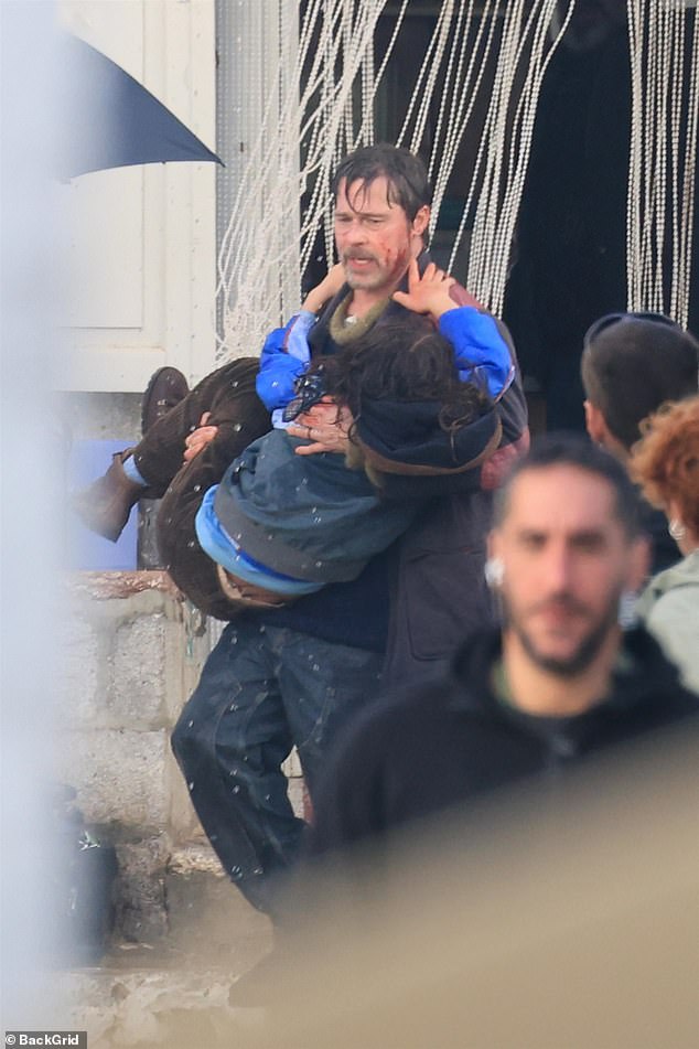 The Hollywood star, 62, was spotted on the Greek island Hydra covered in blood and bruises as he carried a child actress out of a pharmacy