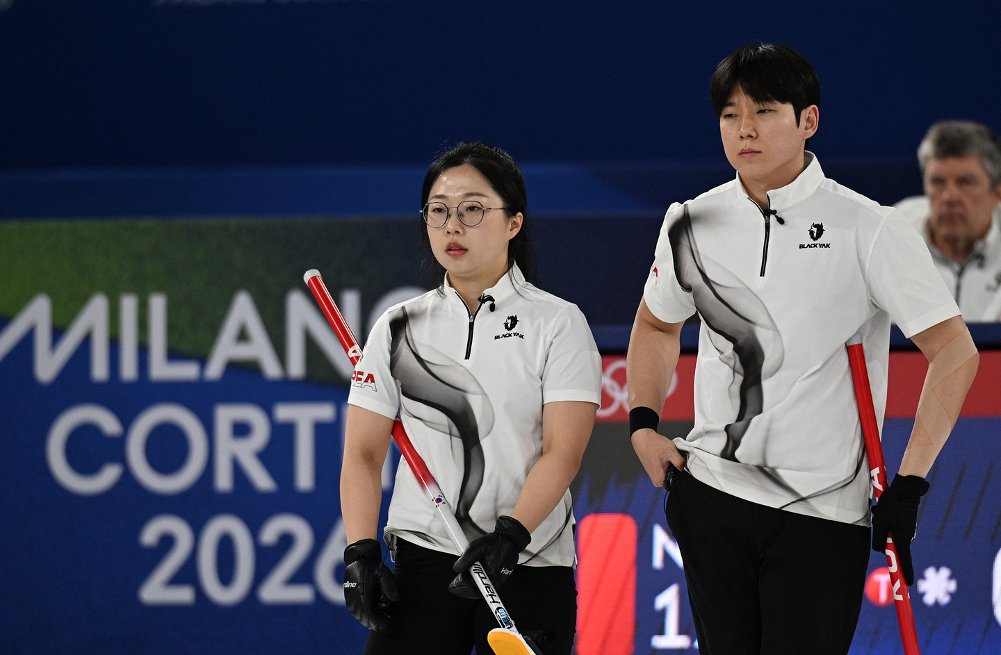 Kim Seon-yeong, left, and Jeong Yeong-seok of Korea look on during their round-robin match against Norway in the mixed doubles curling tournament of the Winter Olympics at Cortina Curling Olympic Stadium in Cortina d'Ampezzo, Italy, on Feb. 9. [REUTERS/YONHAP] 