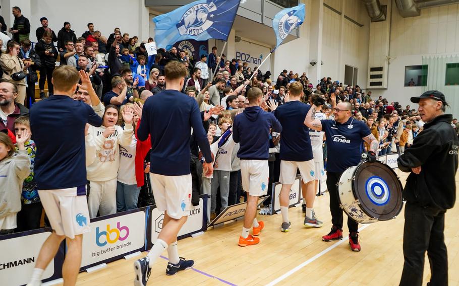 Players greet fans following a basketball game.