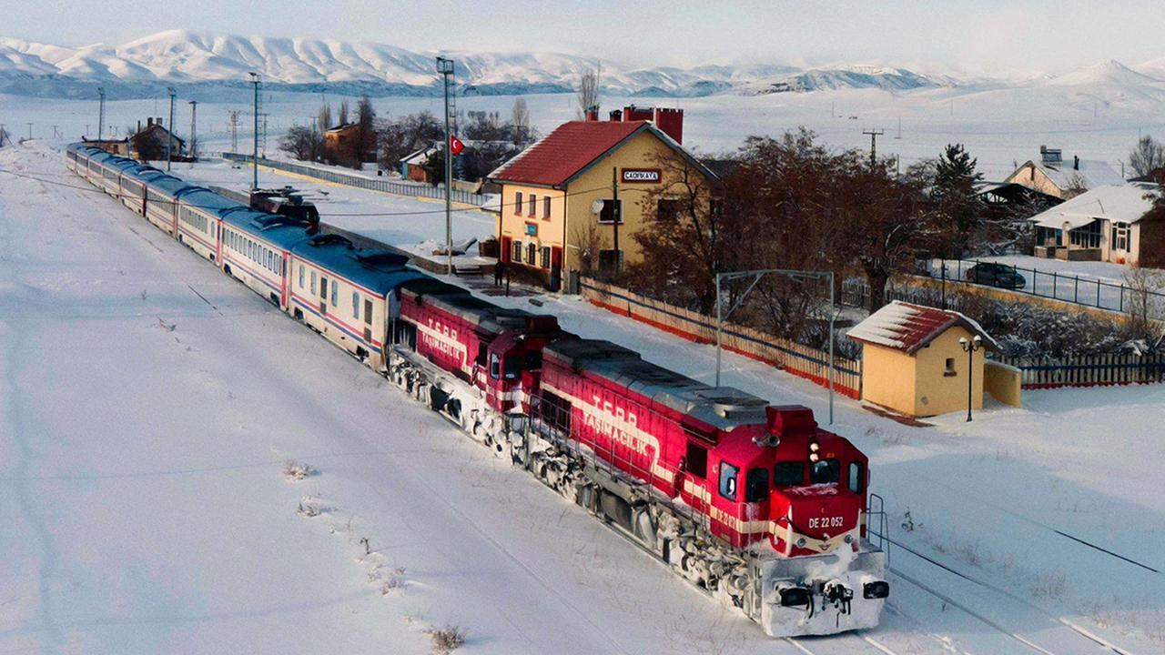 The Eastern Express (Dogu Ekspresi) passes through a picturesque snow-covered station on its iconic route, Türkiye, December 19, 2024. (AA Photo)